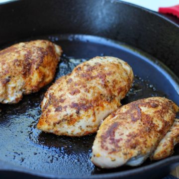3 cooked chicken breasts in a cast iron skillet.