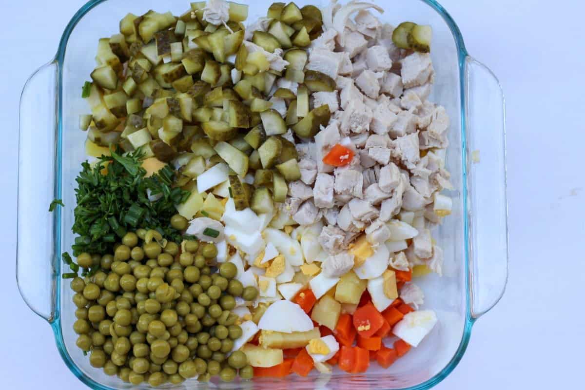 Diced salad ingredients added to the large container. 
