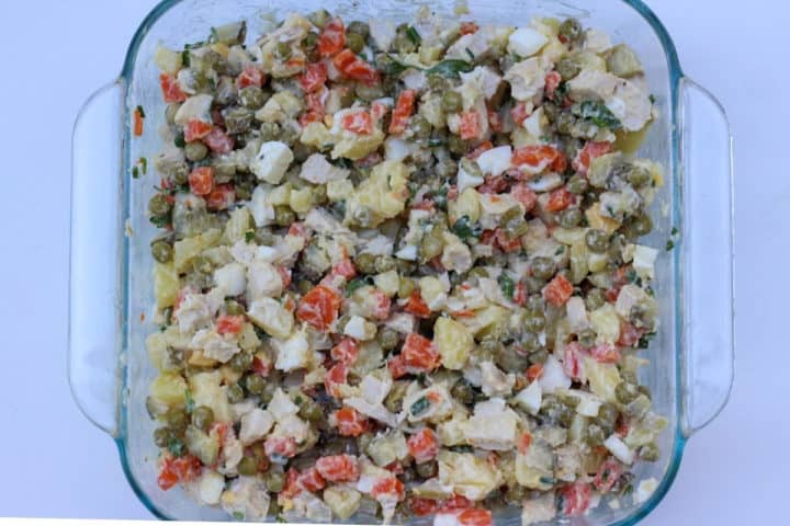 prepared Olivier potatoe salad in a square glass container