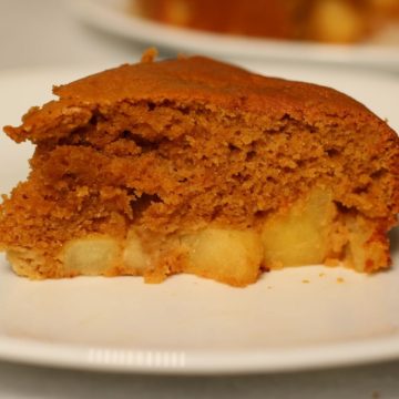 A slice of paleo apple cake on a white plate.