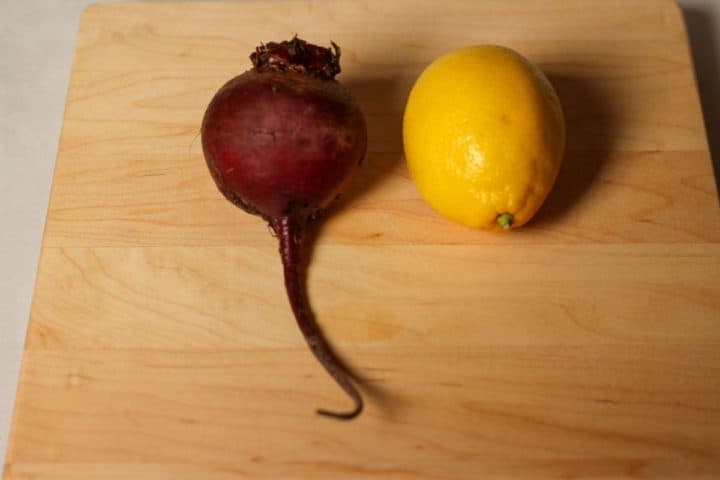 Raw beet next to the medium size lemon. The shot is done for compratison the sizes.