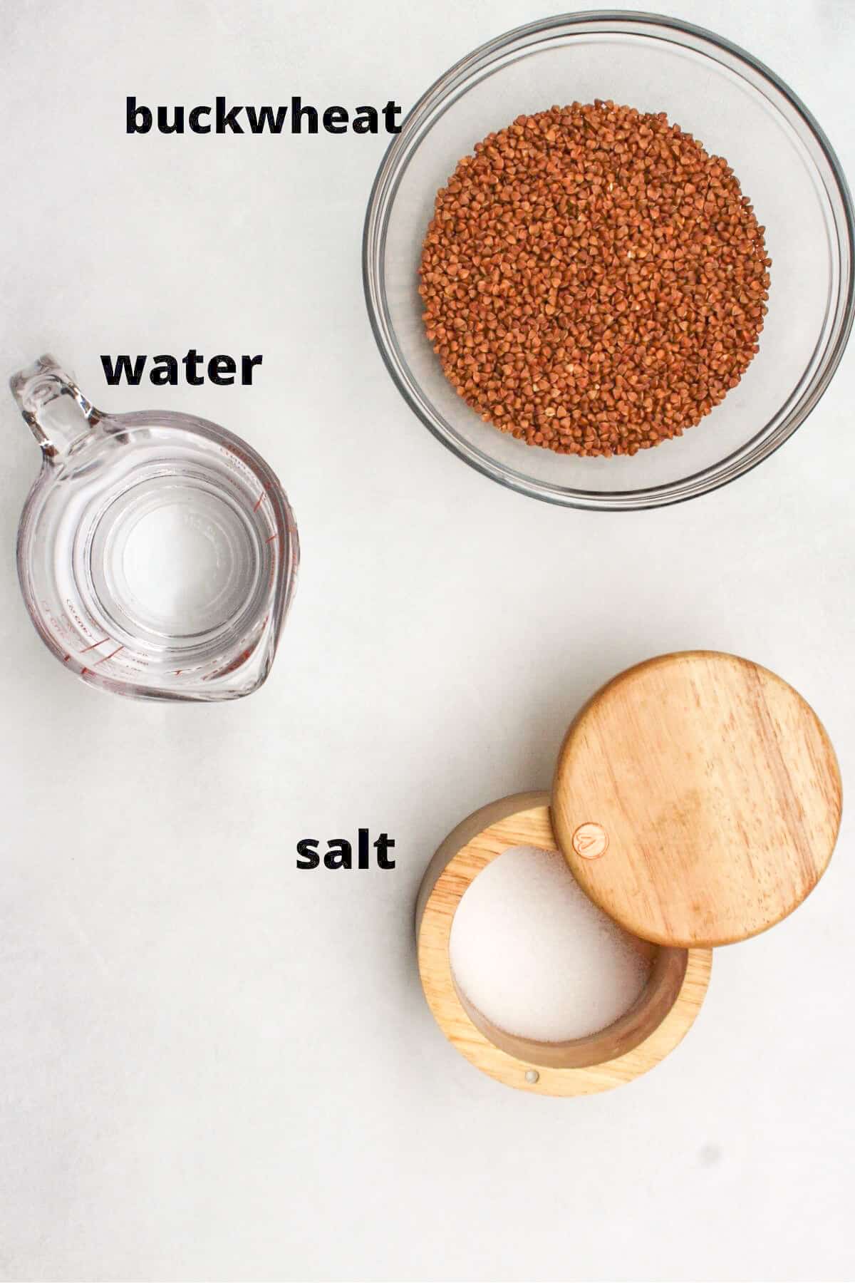 Recipe labeled ingredients on white background. Raw buckwheat, water, salt