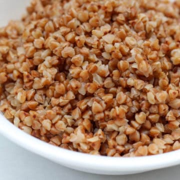 Cooked buckwheat in a white bowl.