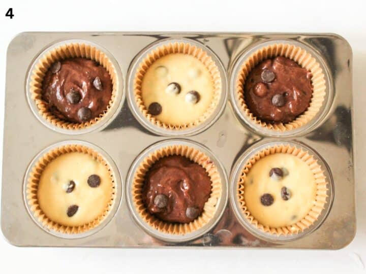 6-muffin pan filled with chocolate chip muffin batter.