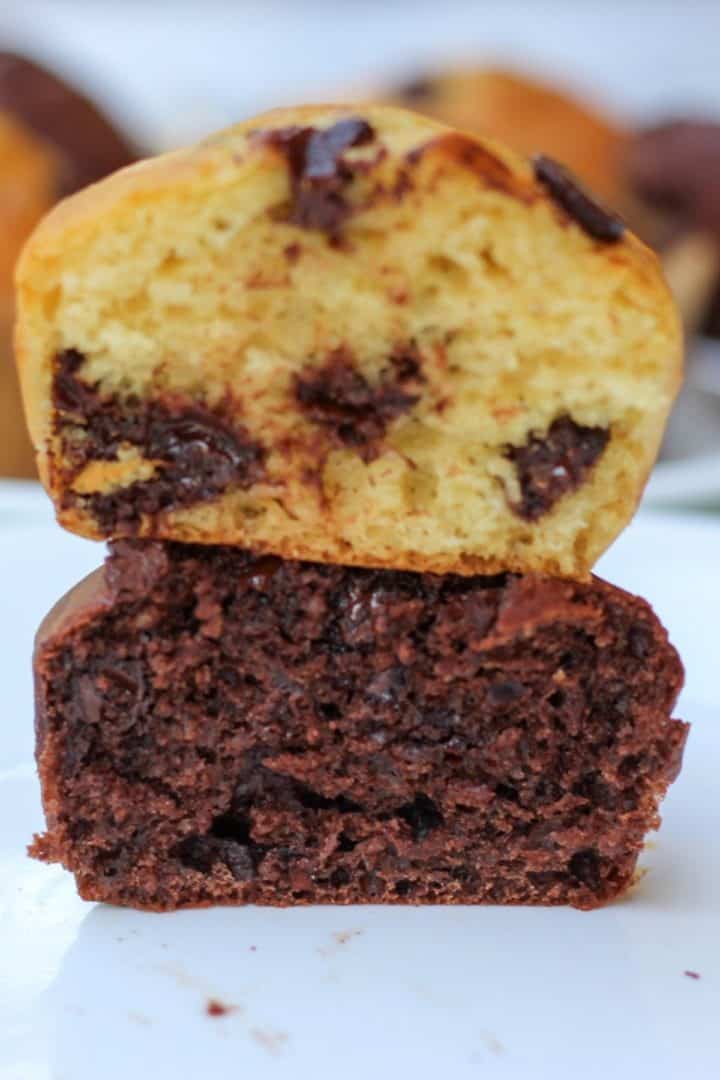 Two halves of muffins stacked on top of each other to show the texture. Bottom one is double chocolate, the top is vanilla chocolate chip.