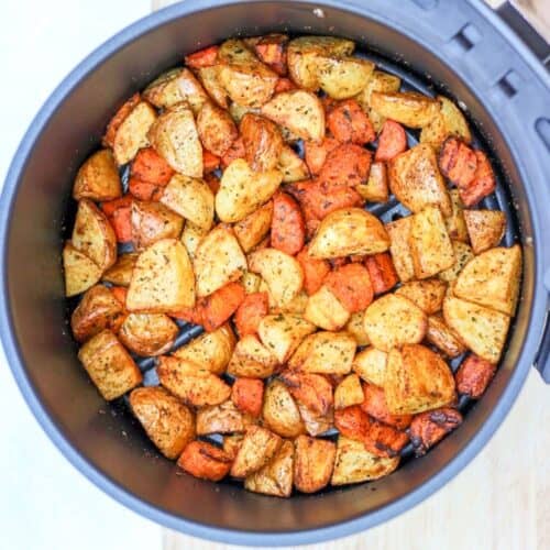 Air fryer roasted carrots and potatoes in air fryer basket.