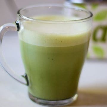 oat matcha latte in a clear mug.