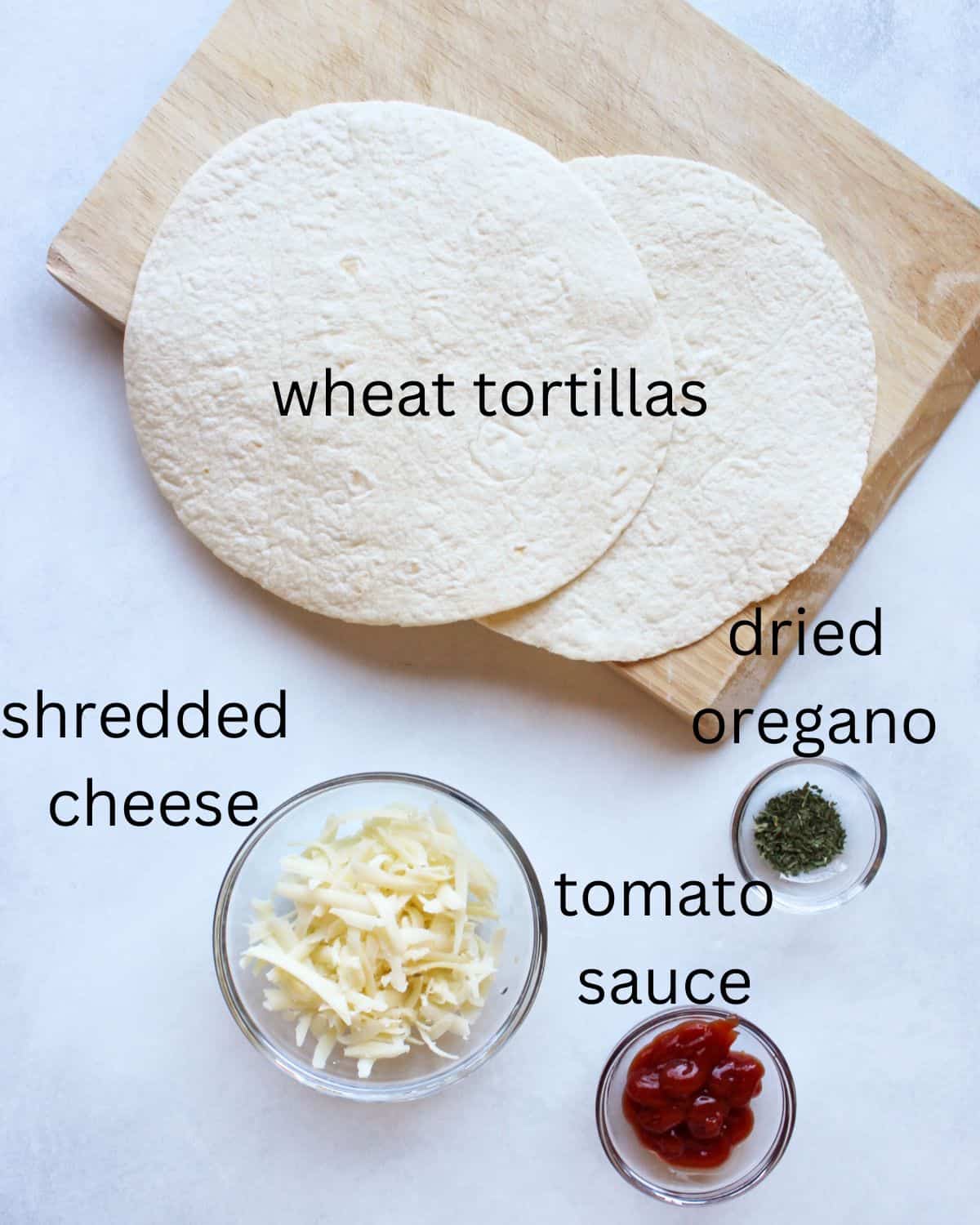 Recipe labeled ingredients on a white background. Two tortillas, shredded cheese, sauce and dried oregano.