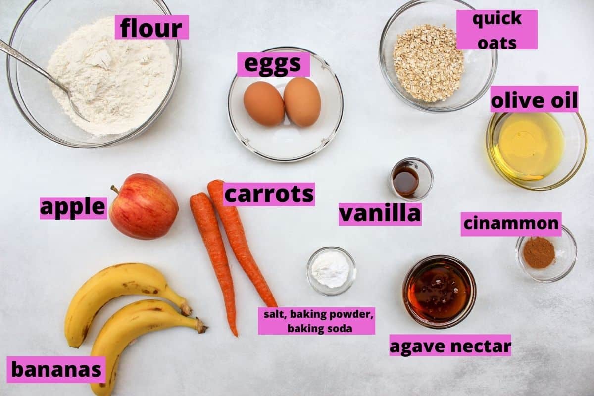 All labeled apple banana carrot muffin ingredients on a white surface.