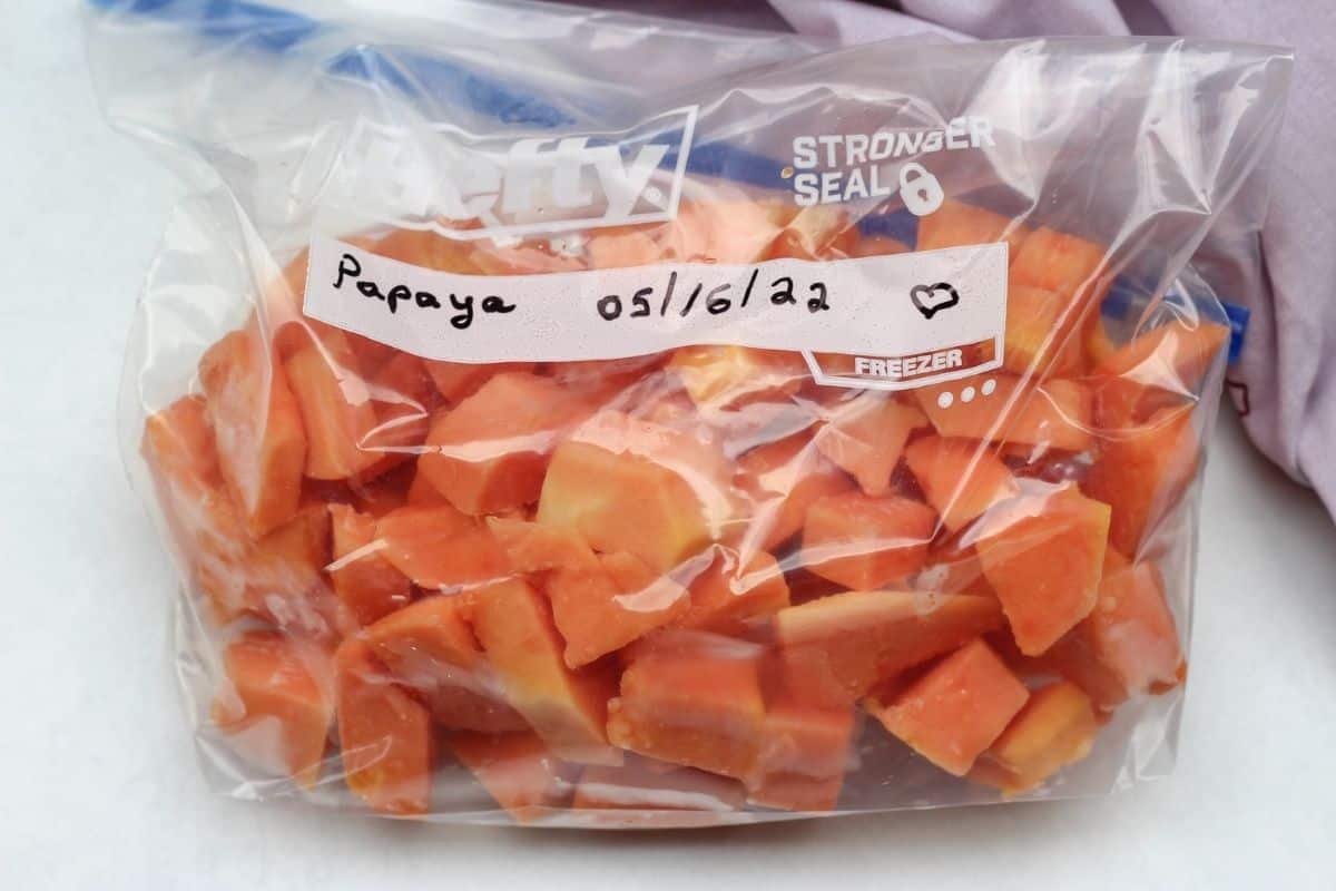 Cubed frozen orange fruit in a bag labeled as papaya 05/17/22