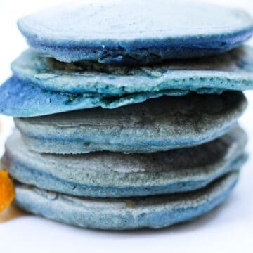 Blue-colored pancakes stacked on top of each other.