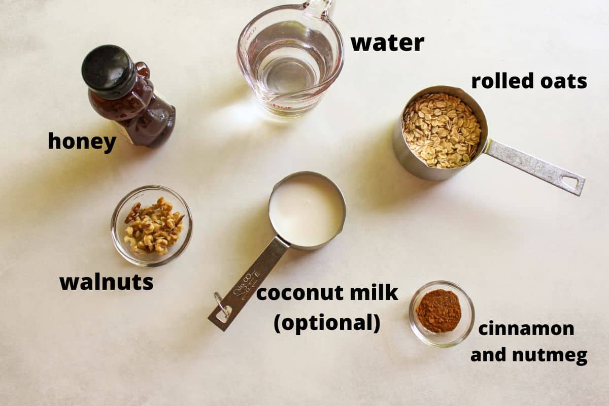 Labeled ingredients on a white background to make a cinnamon spice oatmeal recipe.