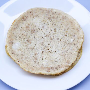 A white egg wrap laying flat on a plate.