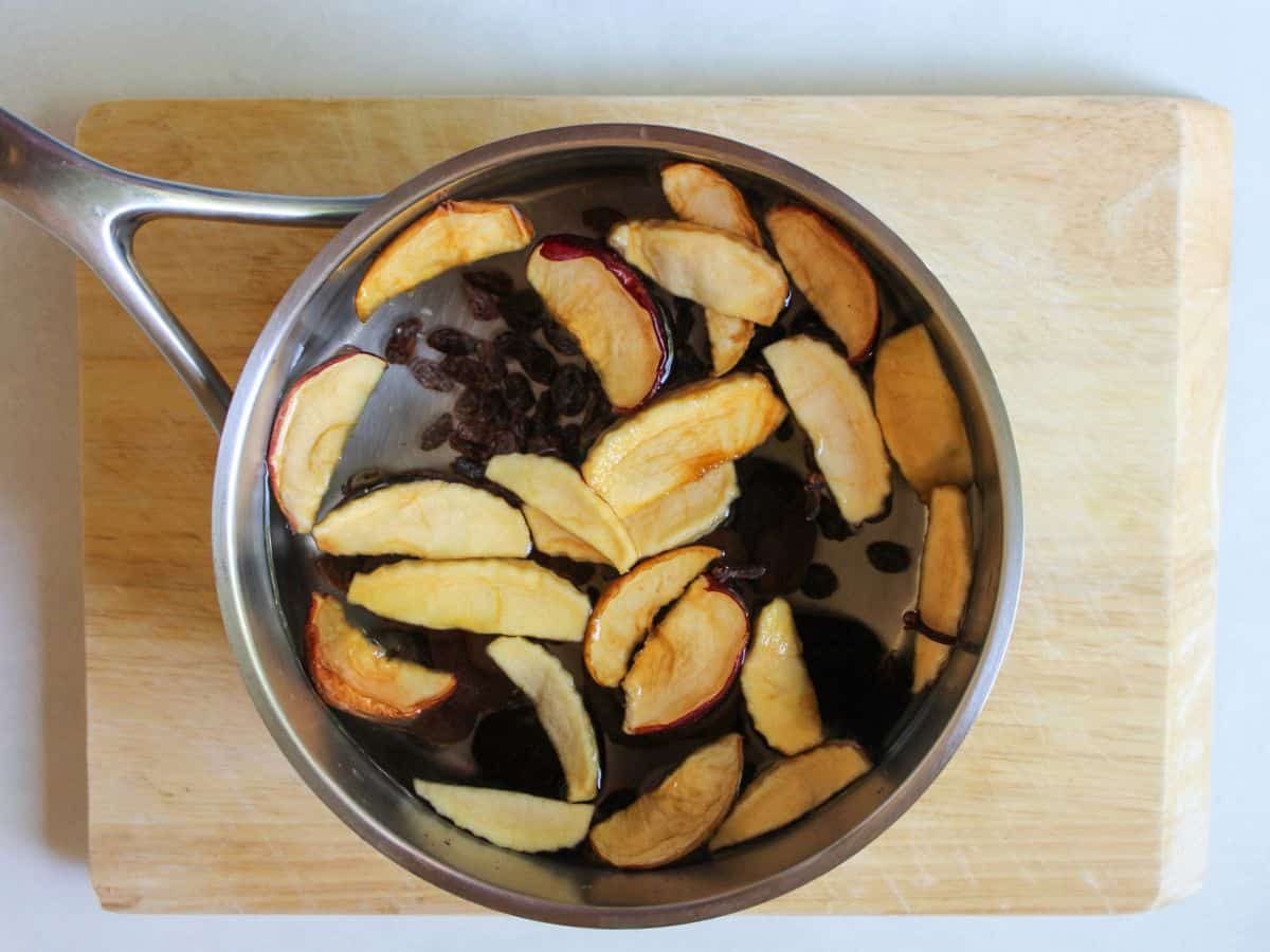 A pot filled with water and dried sliced fruits.