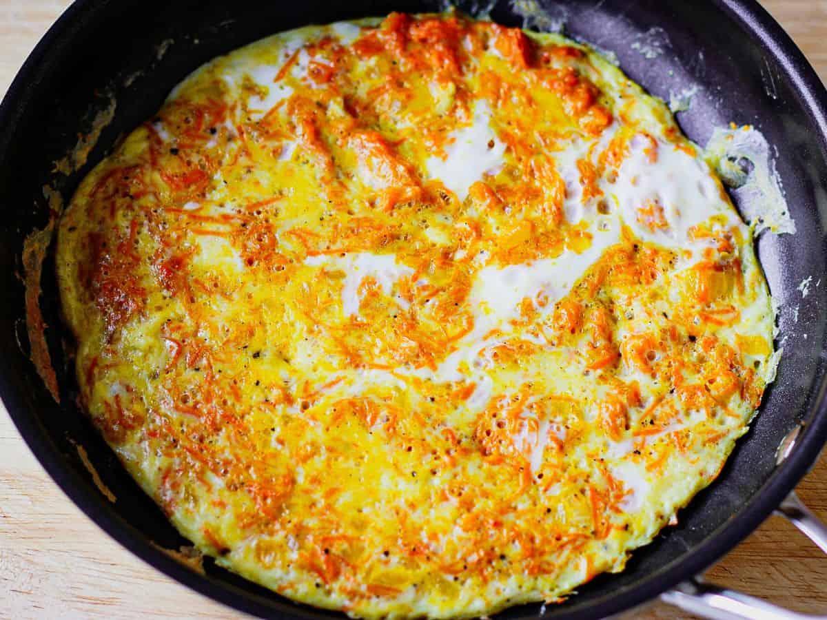 A black skillet with cooked egg dish.