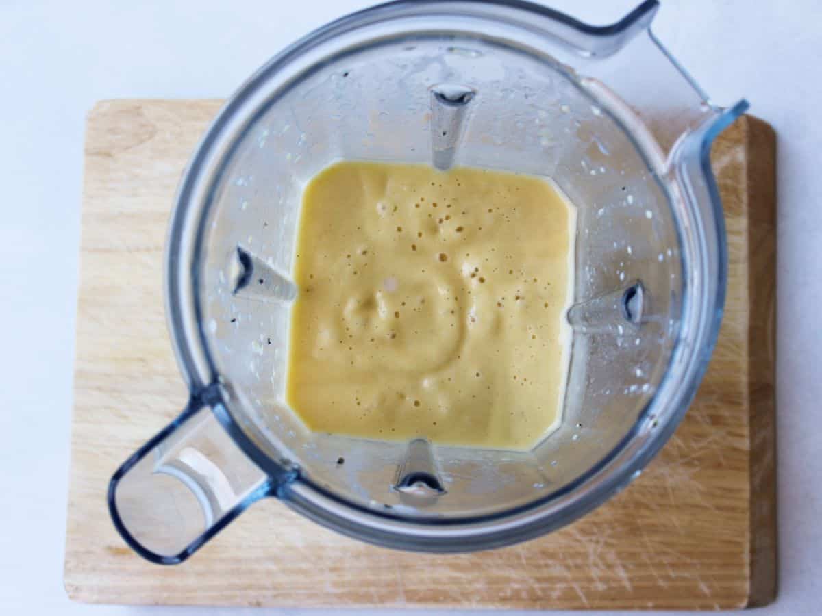 Blender container with blended ingredients into a smoothie.