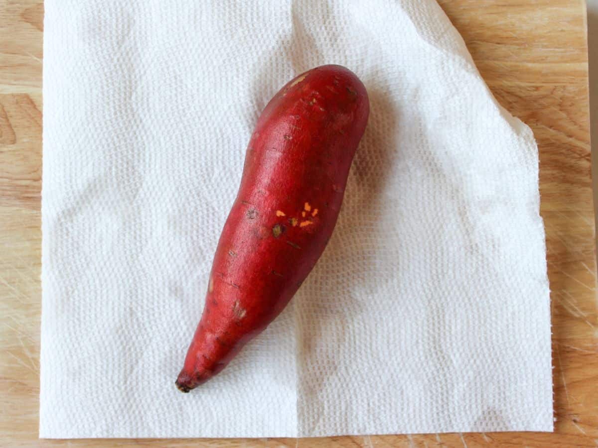 A long red potato on a paper towel.