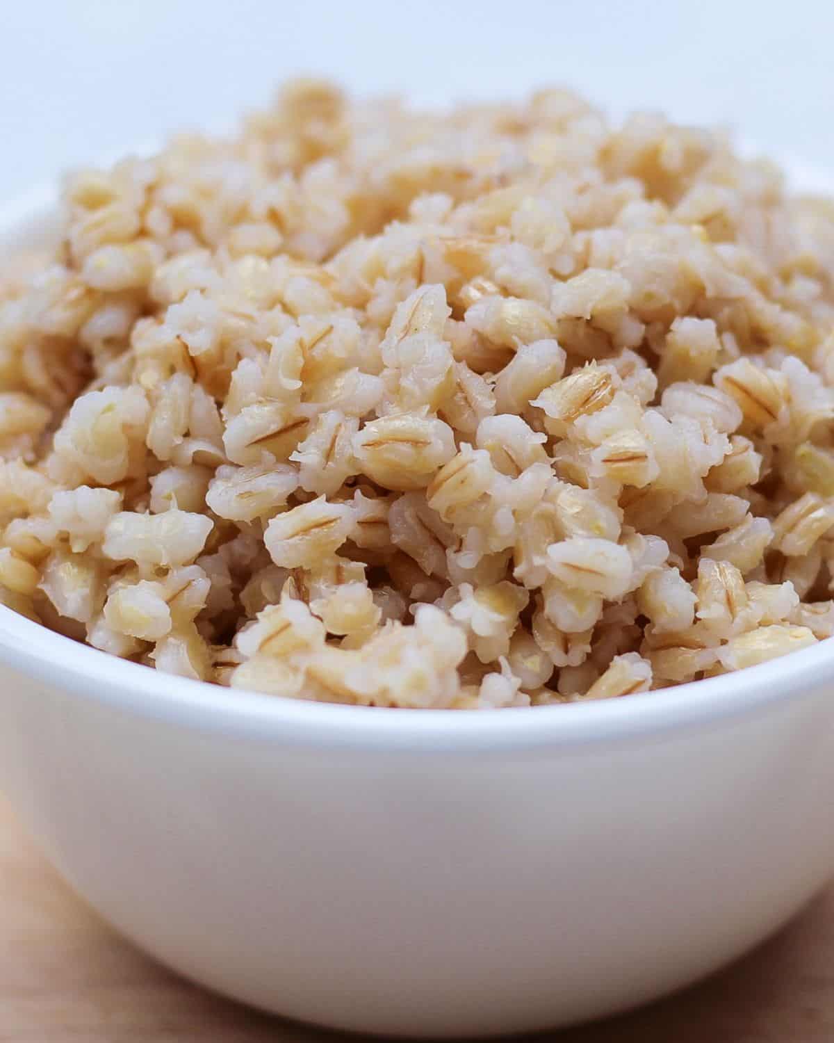 White bowl with cooked barley.