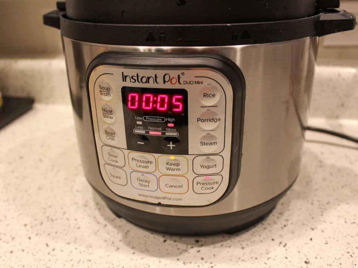 Instant pot panel with set cooking time for 5 minutes.