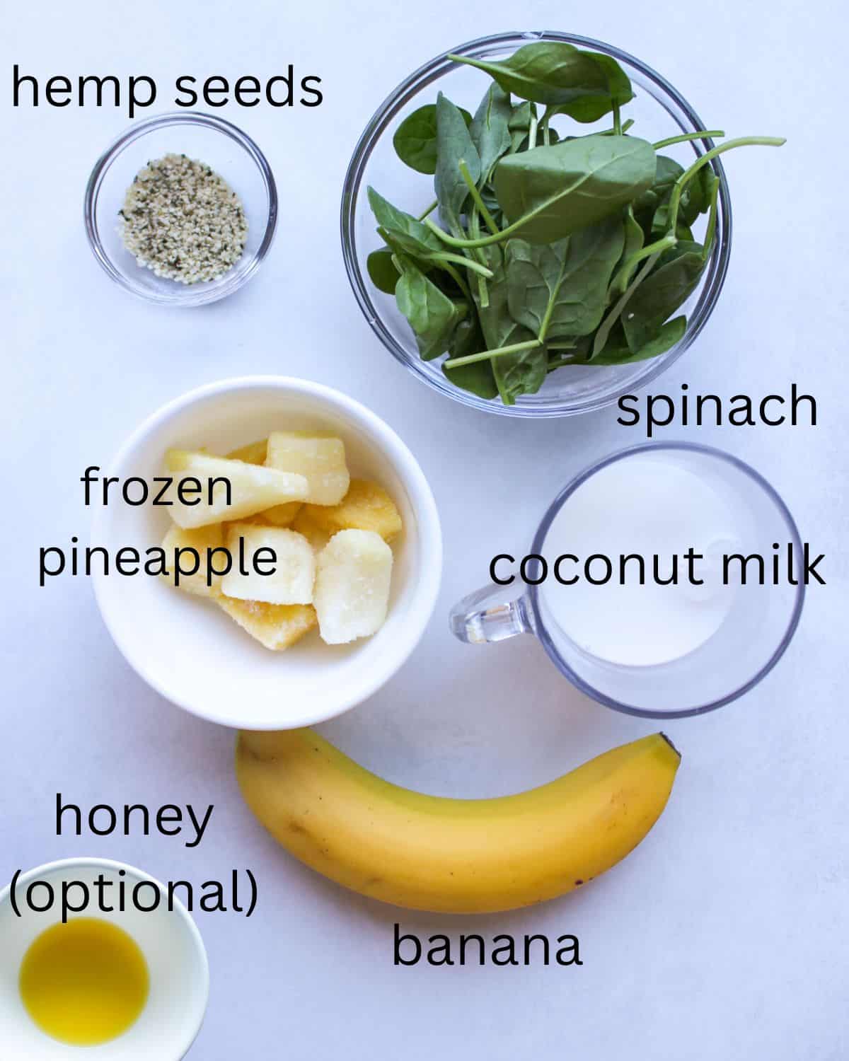 Spinach pineapple smoothie recipe ingredients: baby spinach, hemp seeds, frozen pineapple, coconut milk, whole banana, honey.