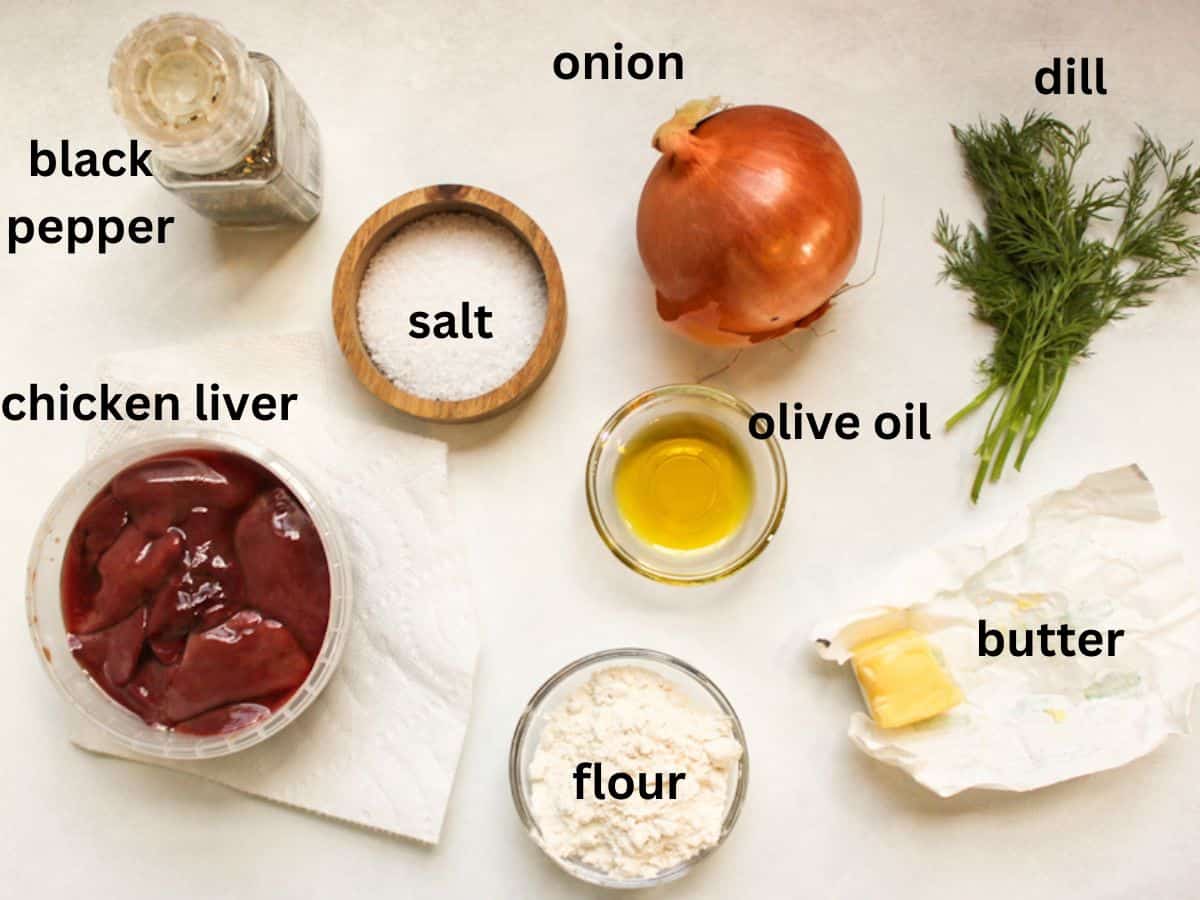 Recipe ingredients on a white background: raw chicken livers, whole large onion, salt, pepper, olive oil, flour and butter.