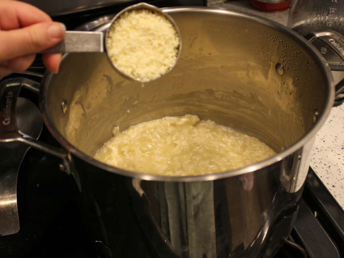 Grated Parmesan being added to the cooked risotto.