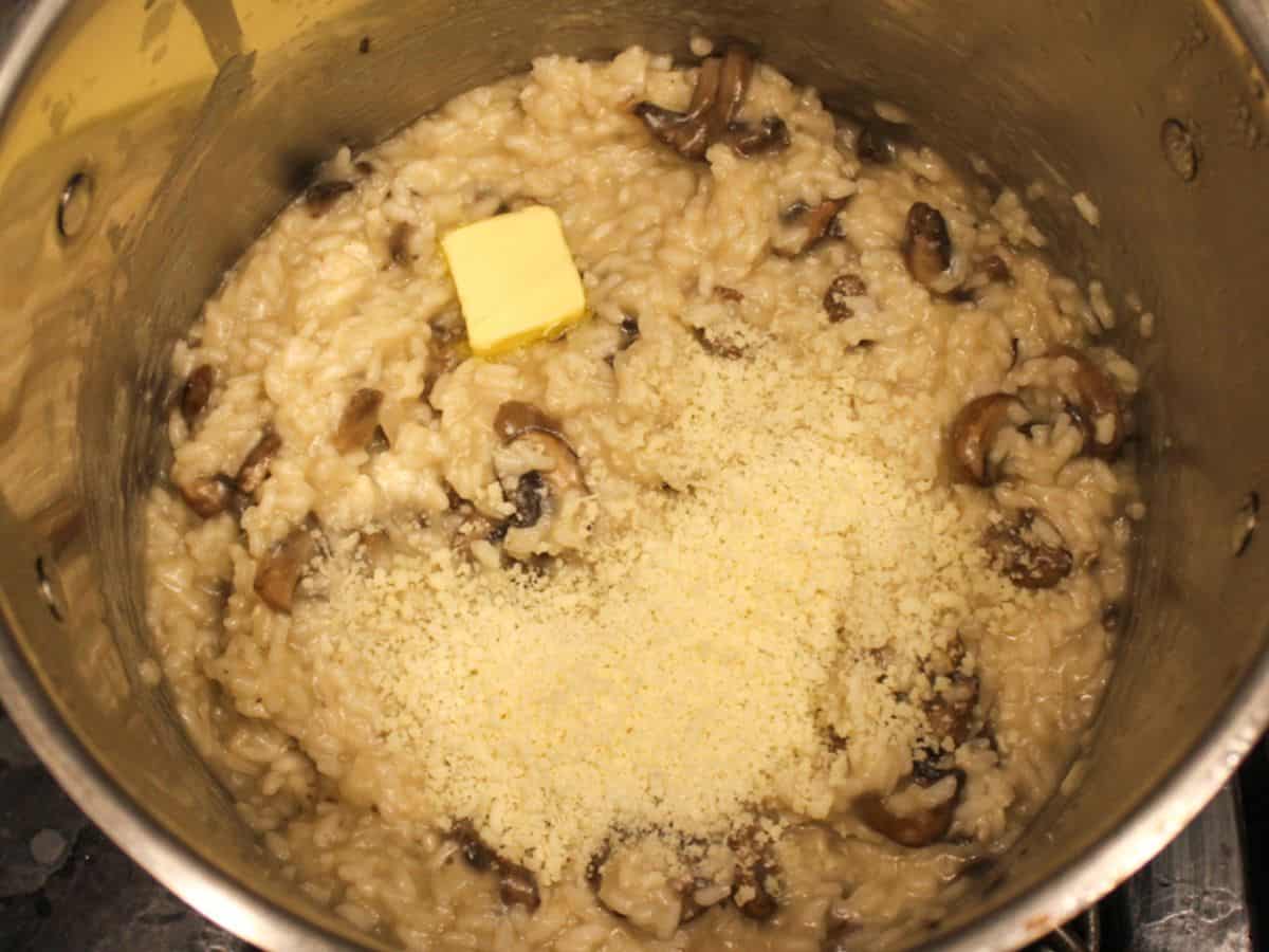 Grated parmigiano-reggiano and butter added to creamy mushroom risotto.