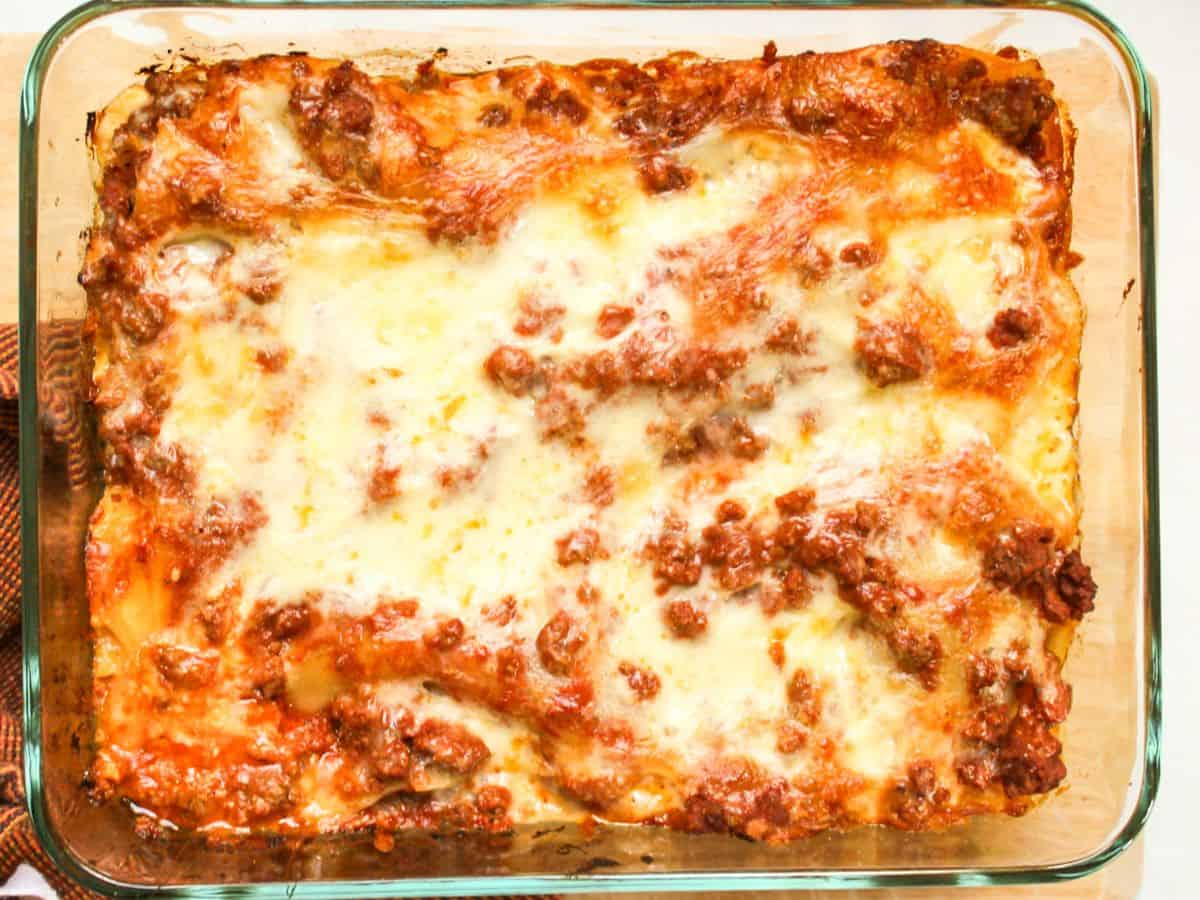 Cooked lasagna in a rectangular glass baking dish.