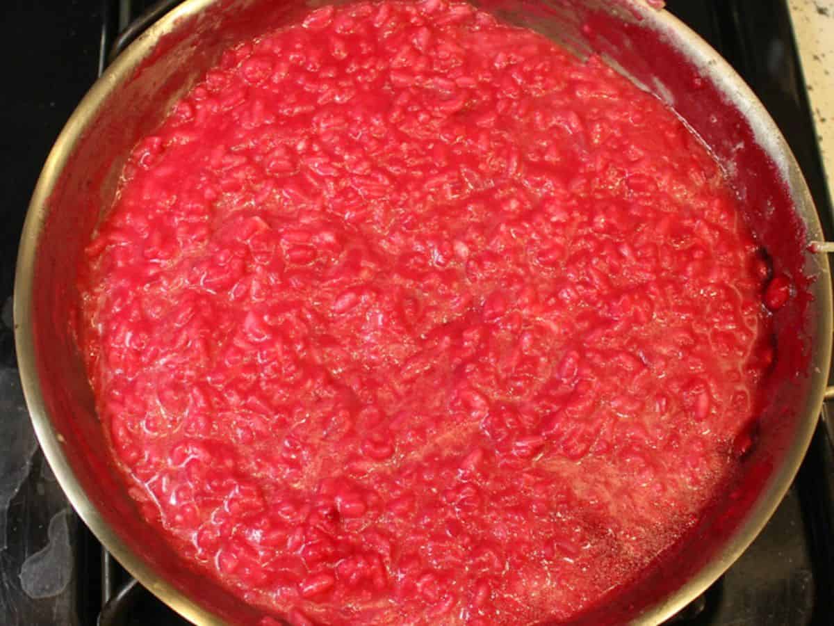 Finished pink risotto rice in a skillet.