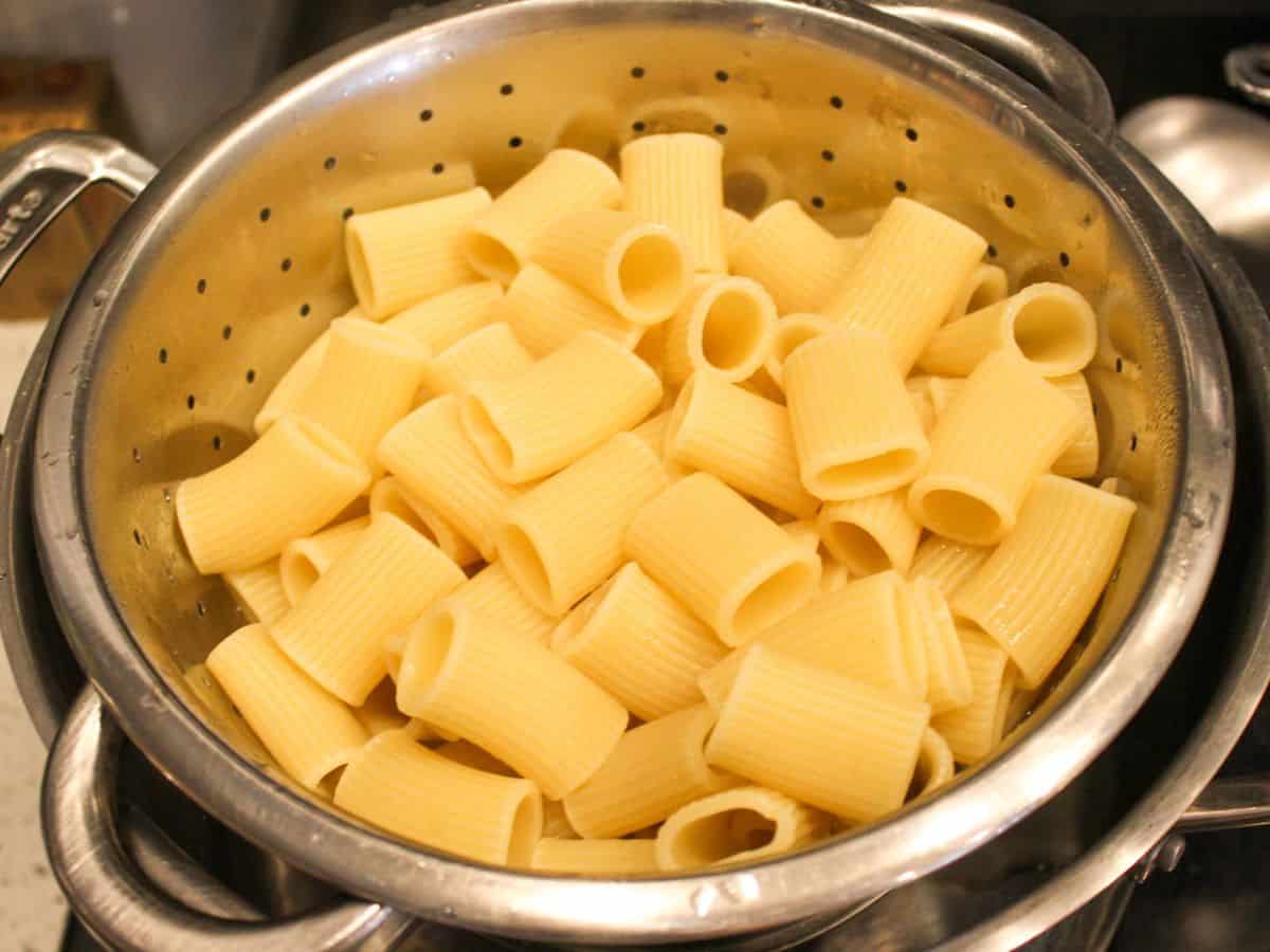 Cooked rigatoni pasta in a colander. 