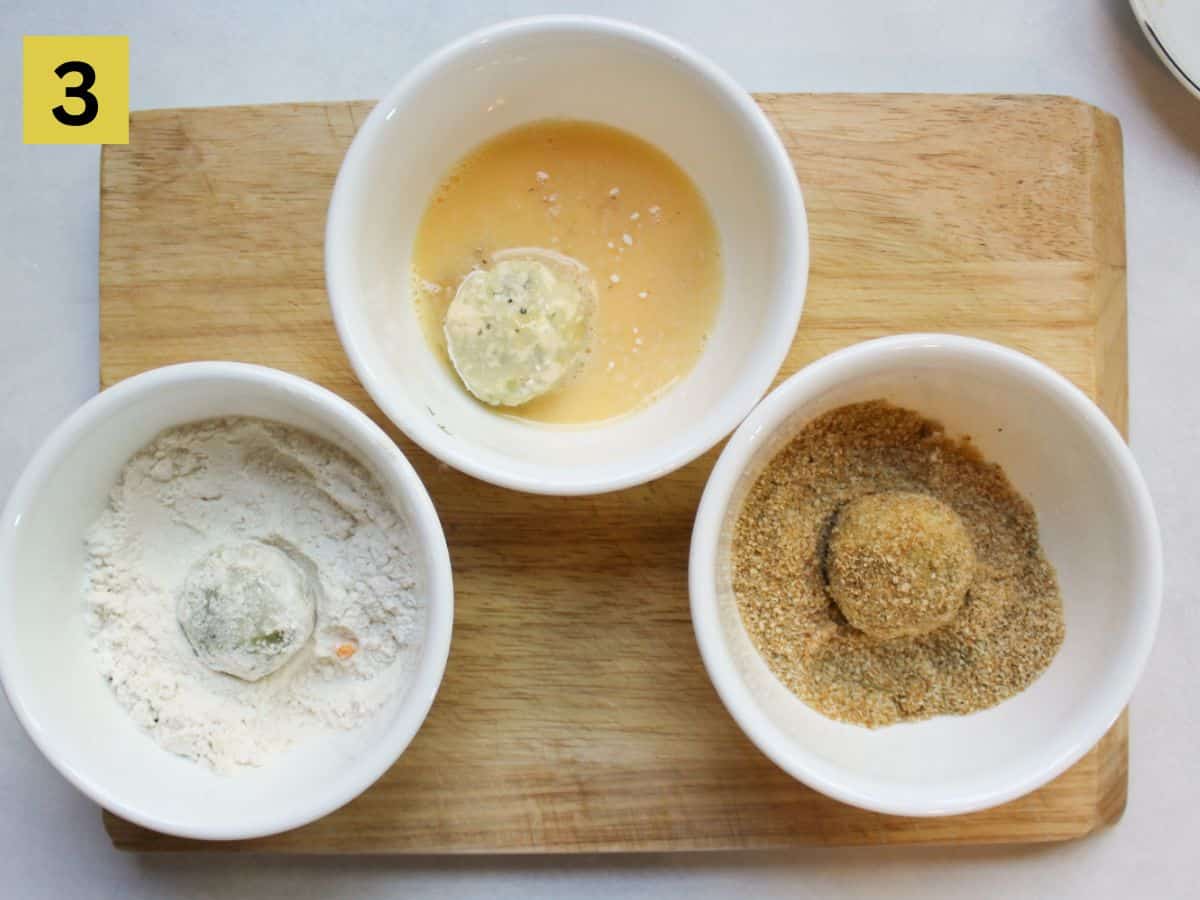 Potato croquettes being dipped in a flour, egg wash and bread crumbs.