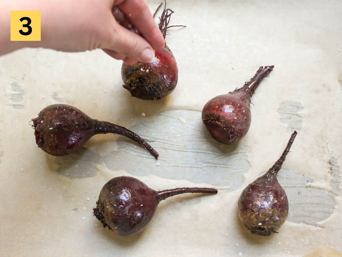 Sprinkling salt over the whole beets arranged on a parchment paper.