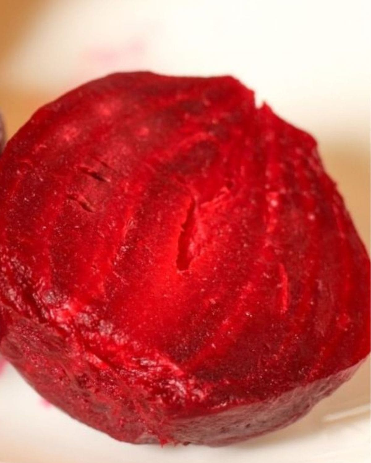 Bright red roasted and peeled beetroot half.