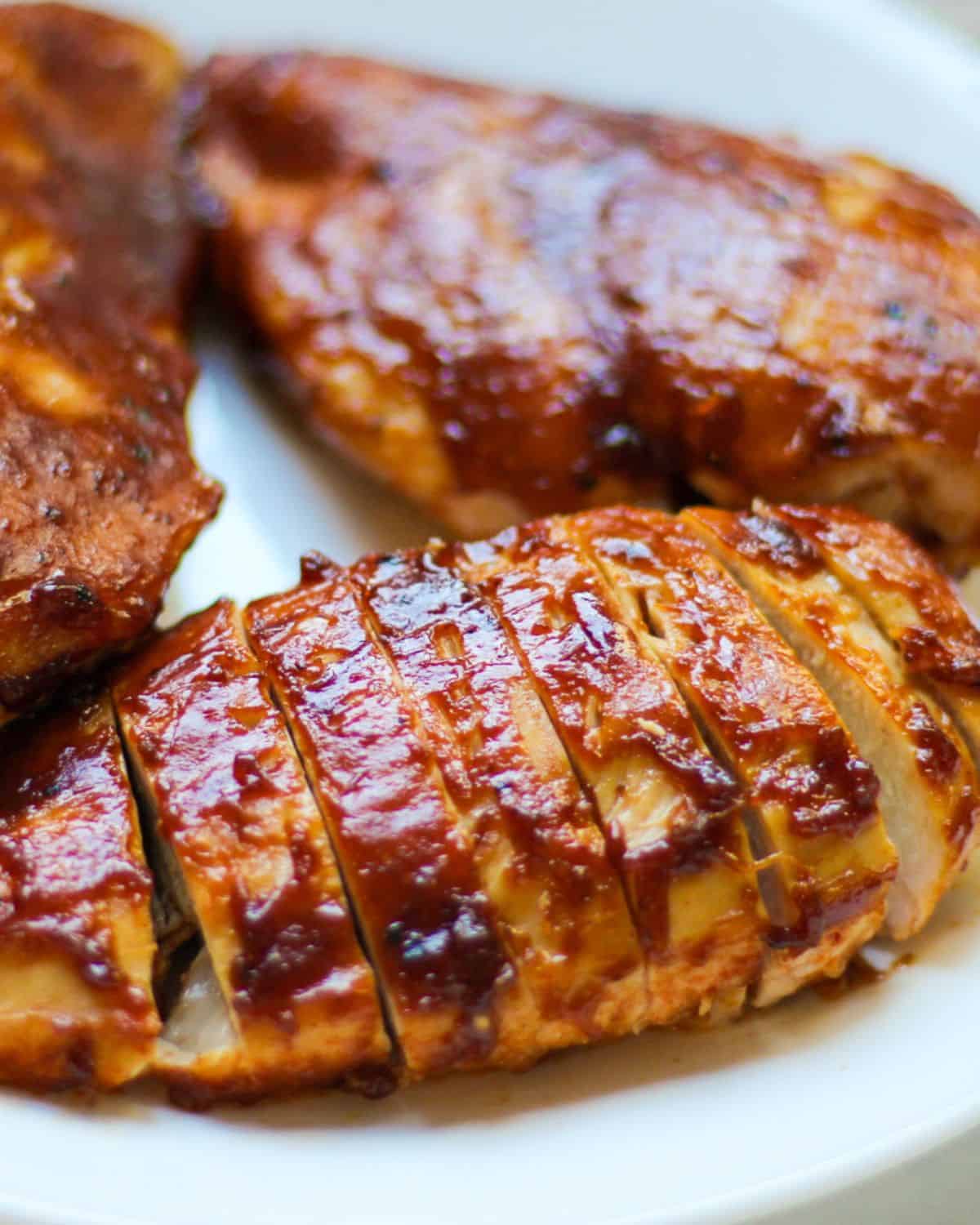 BBQ chicken breast sliced thinly on a plate. 