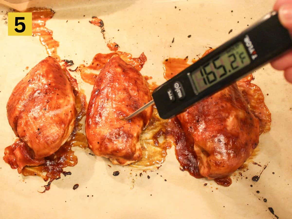 Kitchen thermometer showing 165.2°F inserted in one of the chicken breasts.