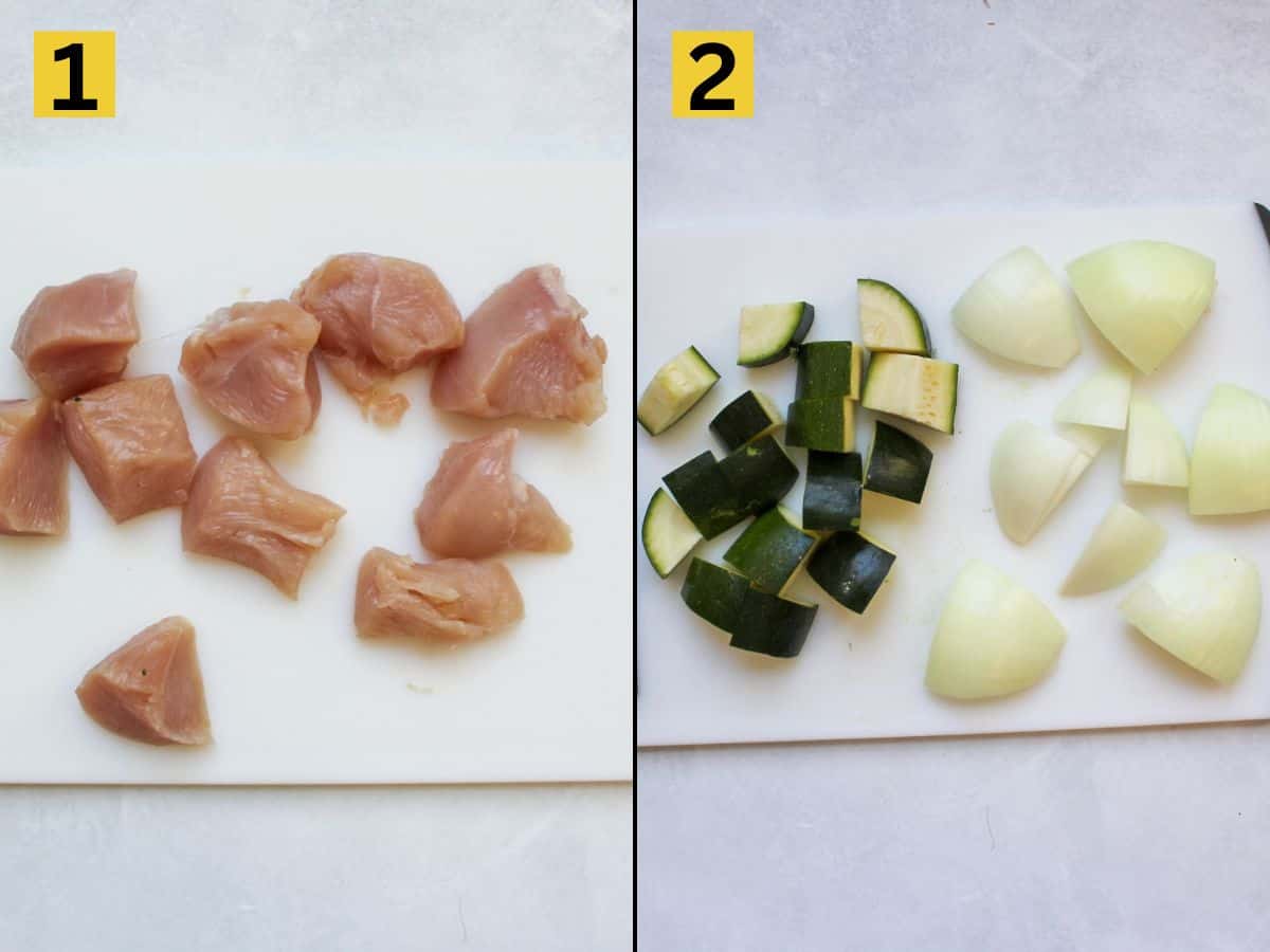 Cut into 1-inch pieces chicken, zucchini and onion on a white cutting board.
