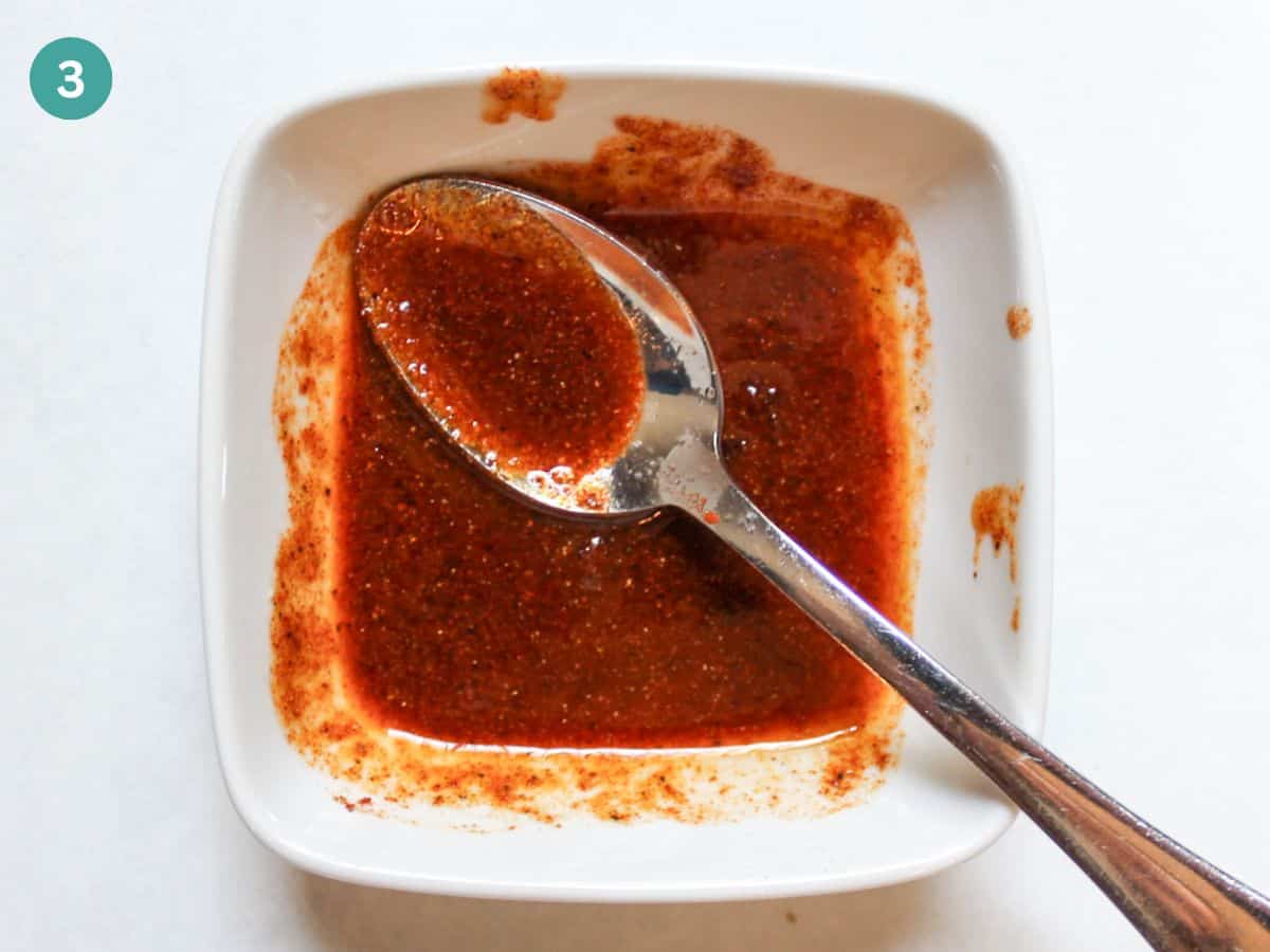 Oil, lemon juice, brown sugar, salt and spices are mixed in a small bowl to create a thick seasonings paste.
