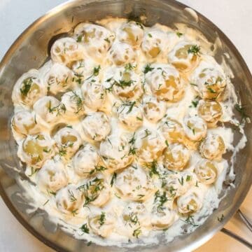 Creamy potatoes in sour cream sauce in a large skillet - easy side dish.