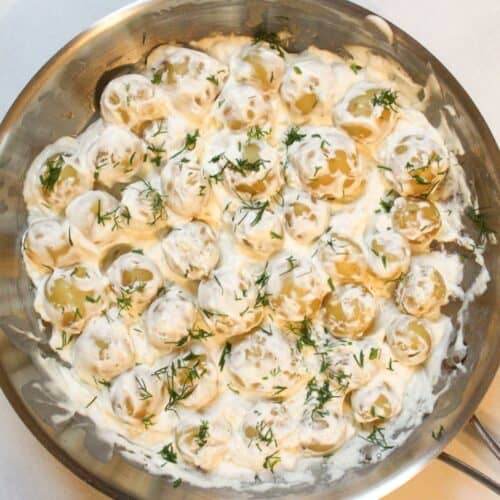 Creamy potatoes in sour cream sauce in a large skillet - easy side dish.