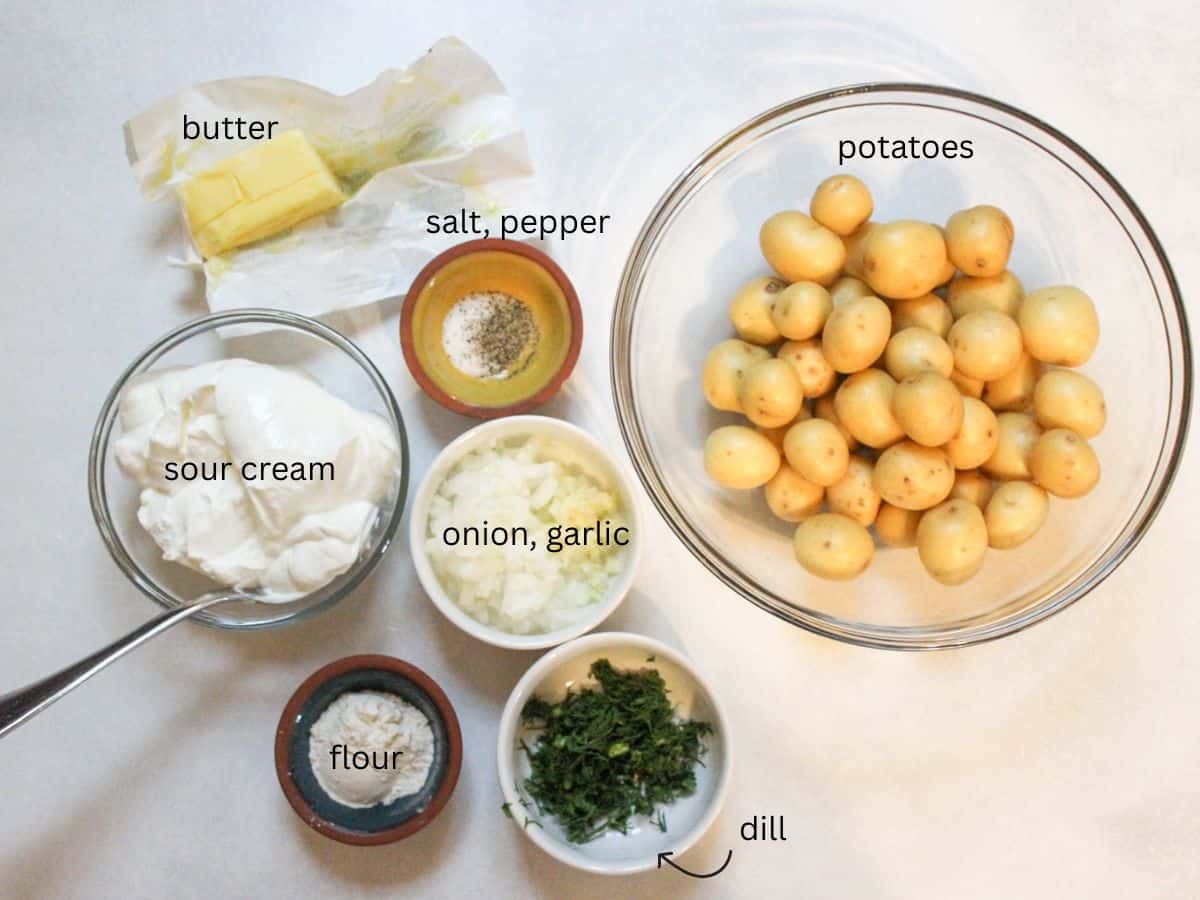 Recipe ingredients on a white background: sour cream, butter, onion, garlic, flour, salt, pepper, baby potatoes, dill.