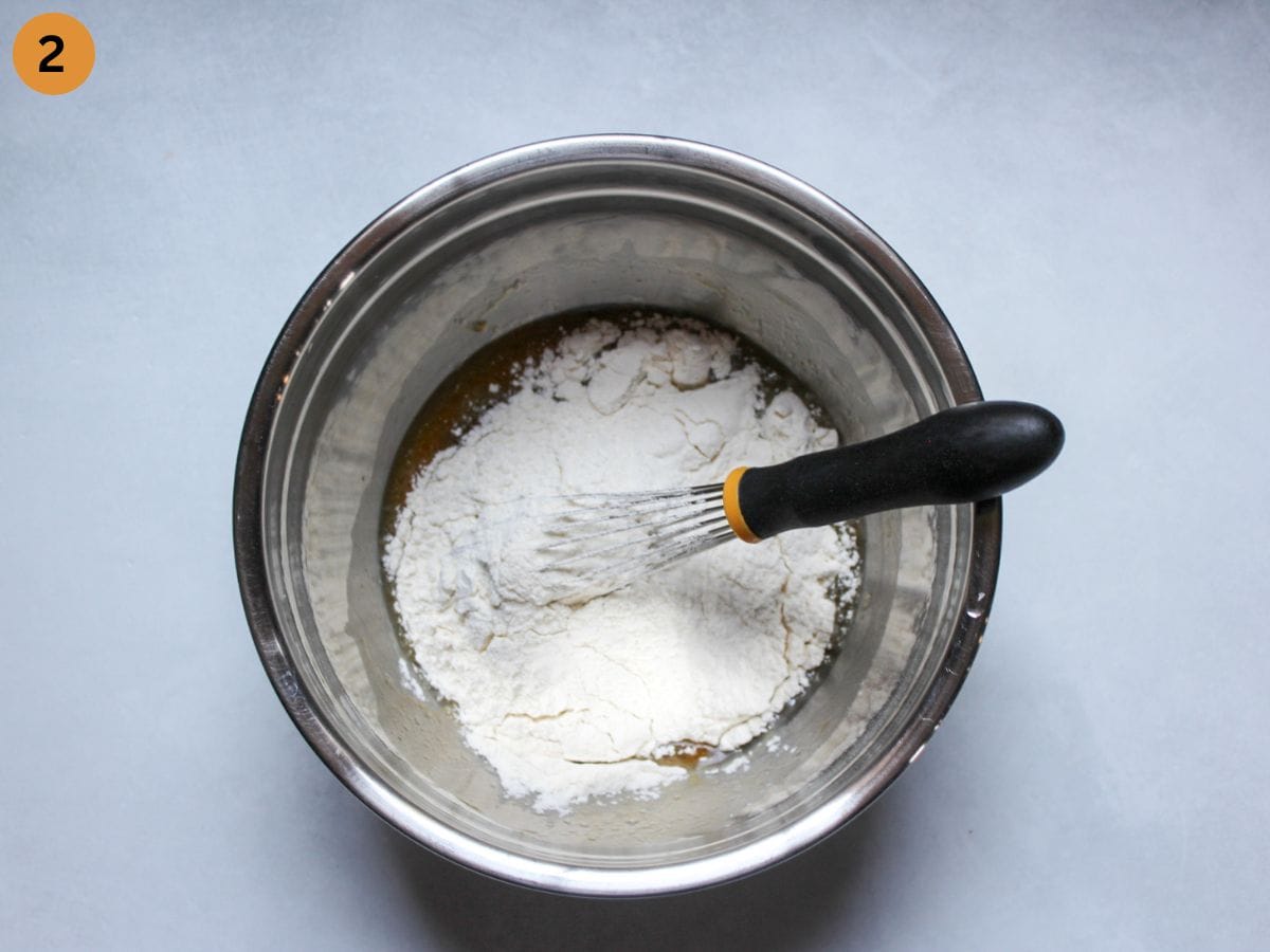 Adding all-purpose wheat flour to the eggs mixture. 