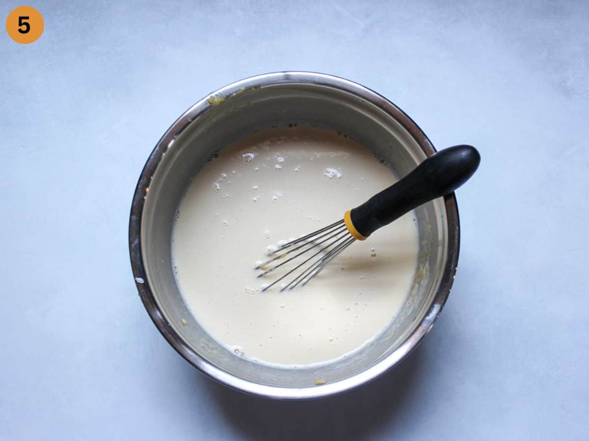 Thin crepe batter resting in a large bowl. 