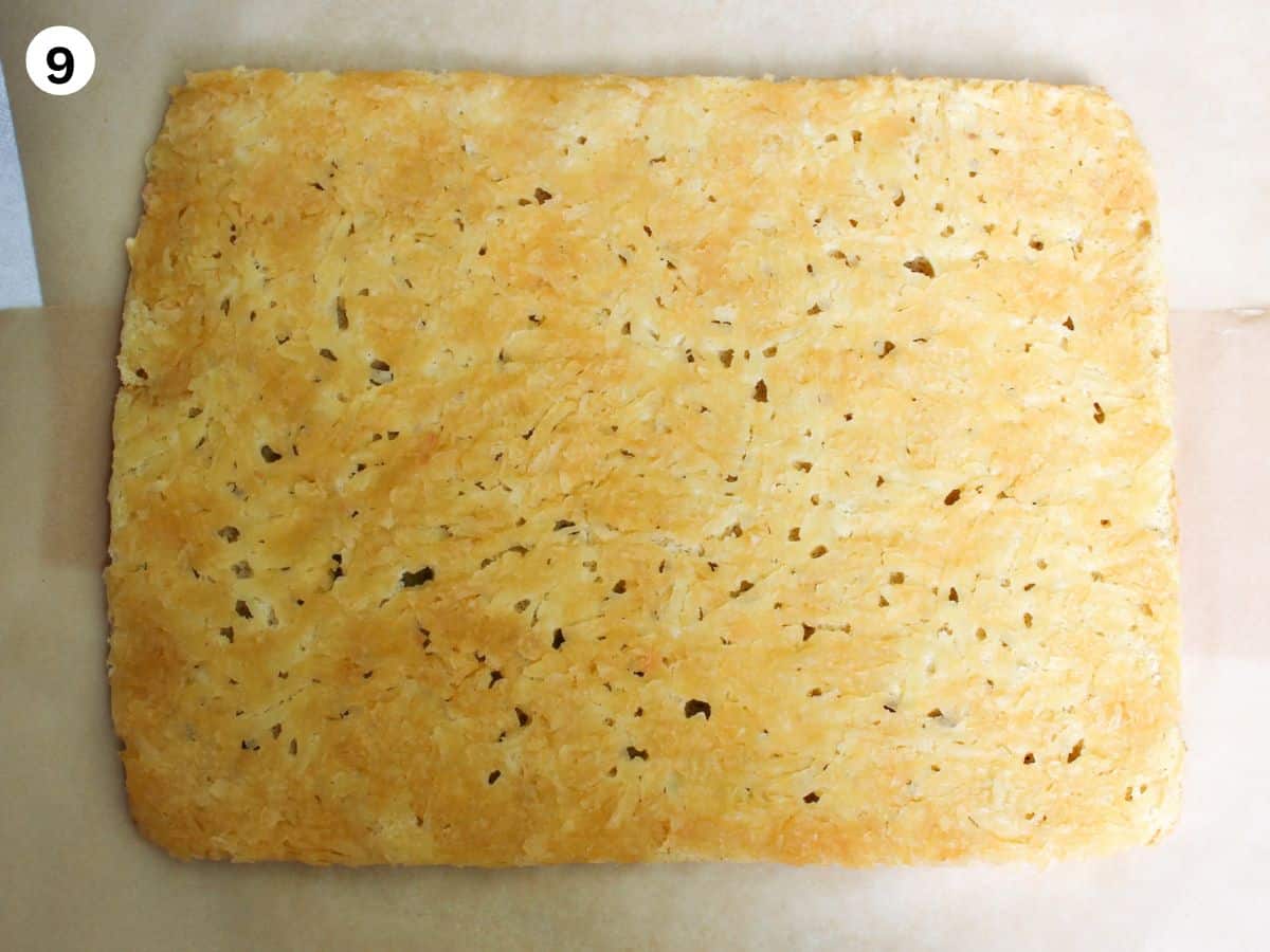 The cake flipped over on a parchment paper so the apple filling is on top. 