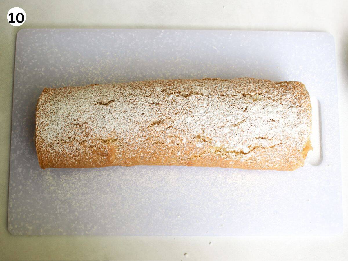 Apple cake rolled into a log and dusted with powder sugar. 