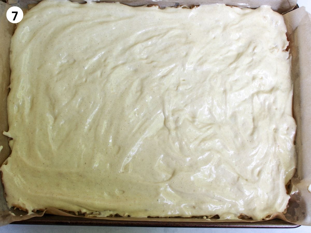 Sponge cake batter spread evenly on top of the apples. 