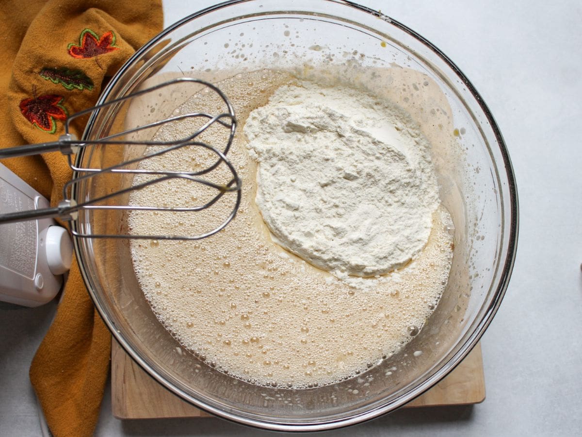 Mixing honey cake batter with electric mixer.