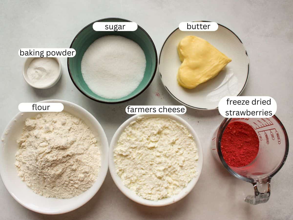 Ingredients for hear-shaped cookies including farmer's cheese, butter. sugar, flour, baking powder, freeze dried strawberries. 