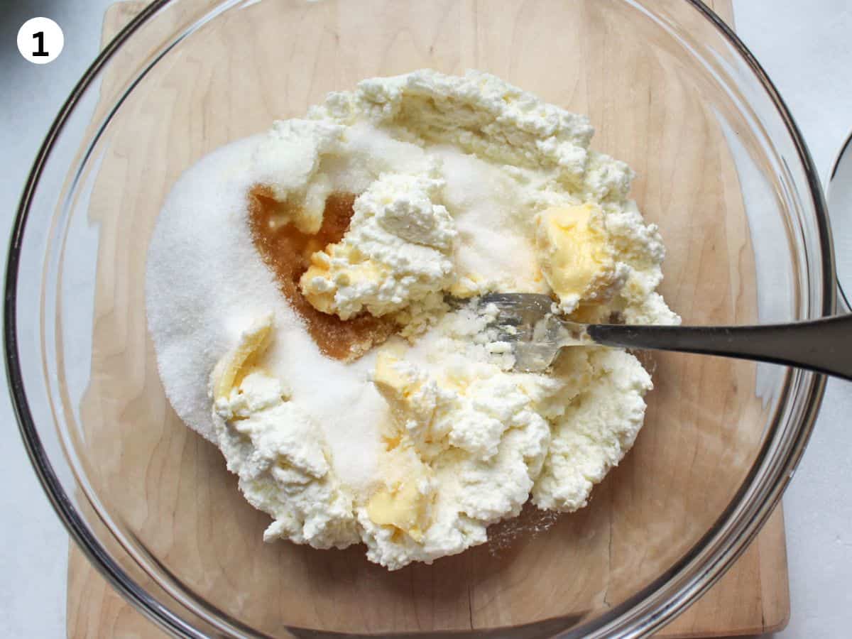 Mixing cottage cheese, softened butter, and sugar in a bowl for a cookie dough. 
