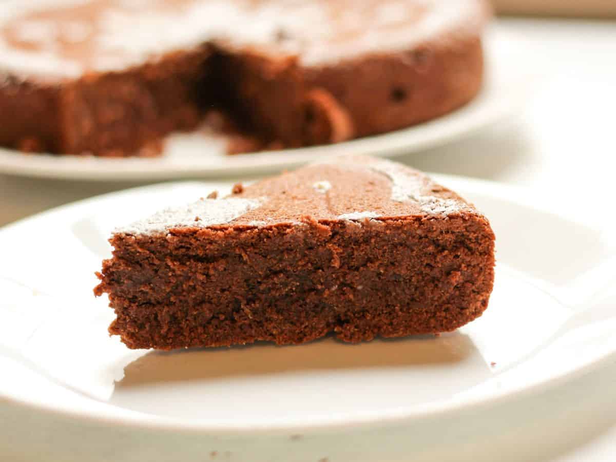 A slice of Italian chocolate almond cake with rich, fudgy chocolate texture.