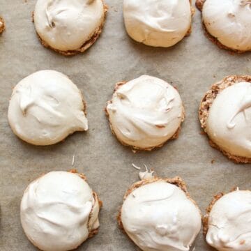 Light and crispy chocolate meringue cookies arranged on a baking pan lined with parchment paper.